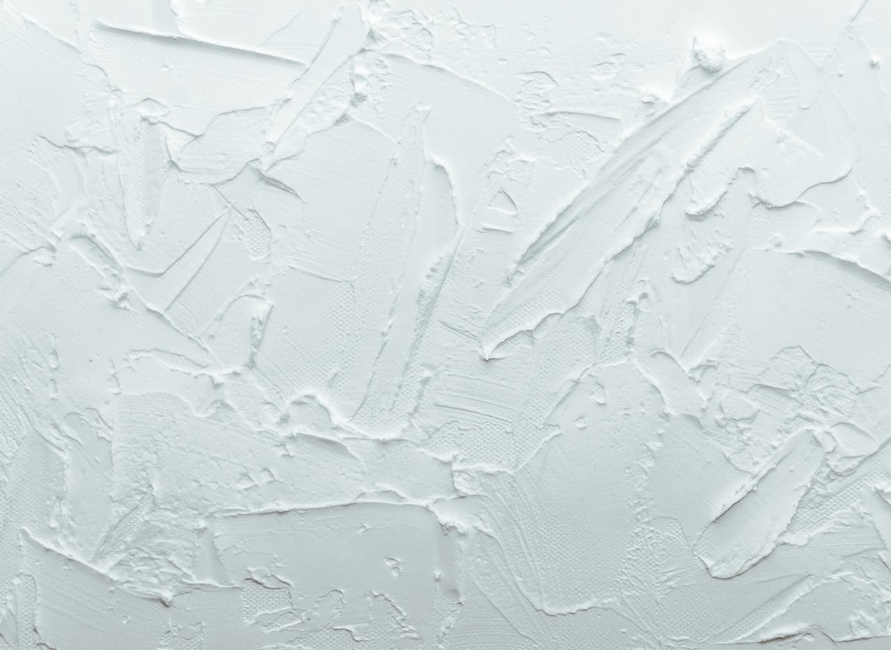 Close-up shot of a white textured surface with abstract patterns, ideal for design backgrounds.